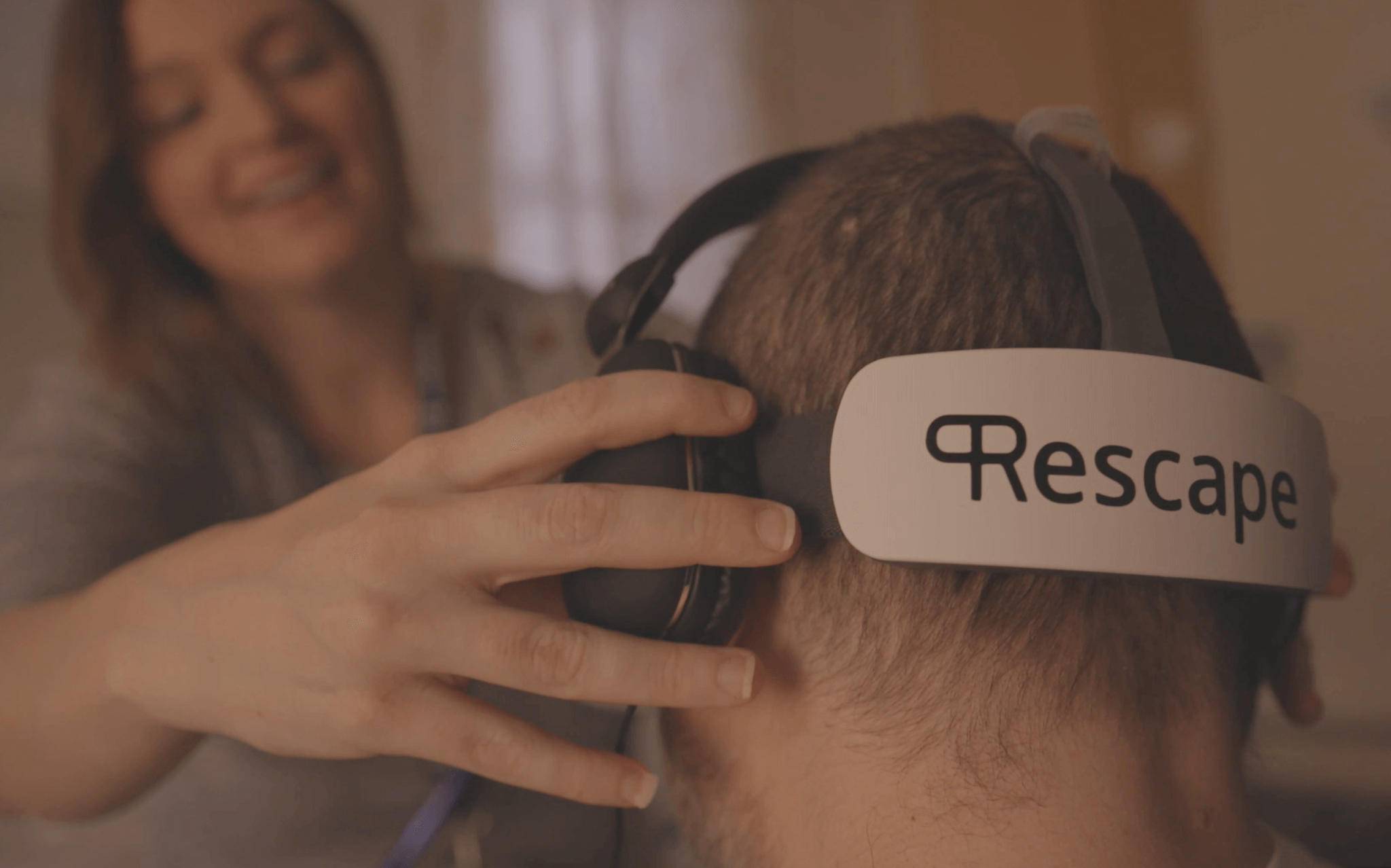 A virtual reality headset is put on a person's head